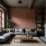 Salon de style industriel avec murs en brique apparente, poutres en acier et mobilier en cuir gris anthracite